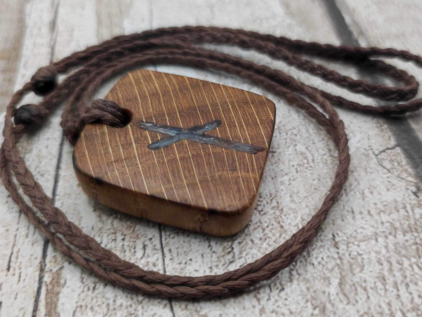 Nauthiz oak rune pendant with blue kyanite inlay.