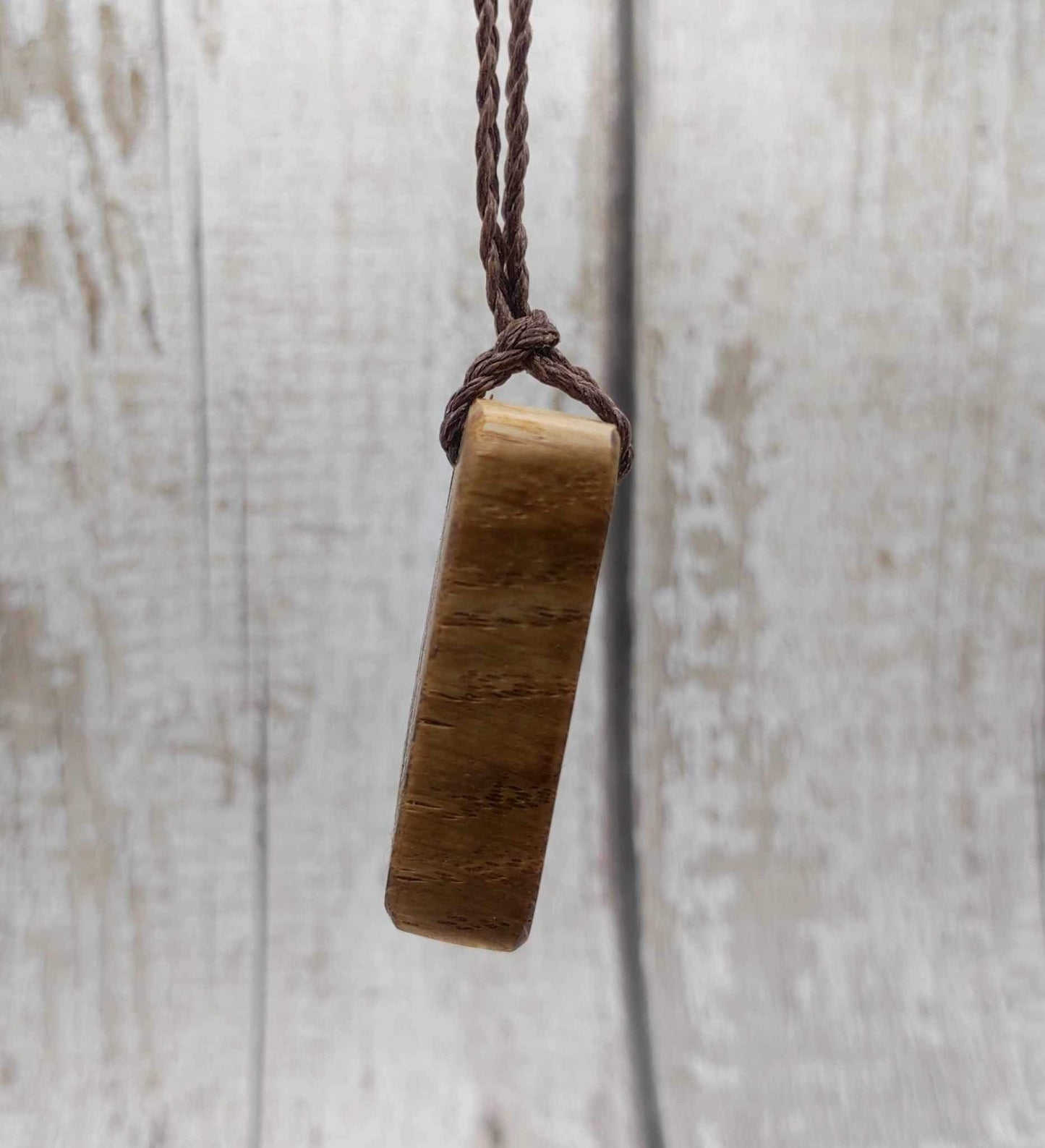 Oak wood Uruz rune pendant with Pāua shell.