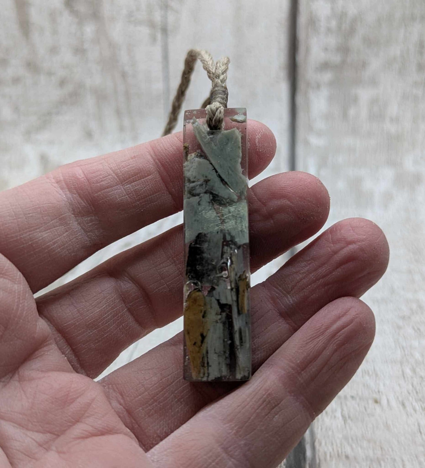 New Zealand Pounamu greenstone chip pendant in Uv resin casting.