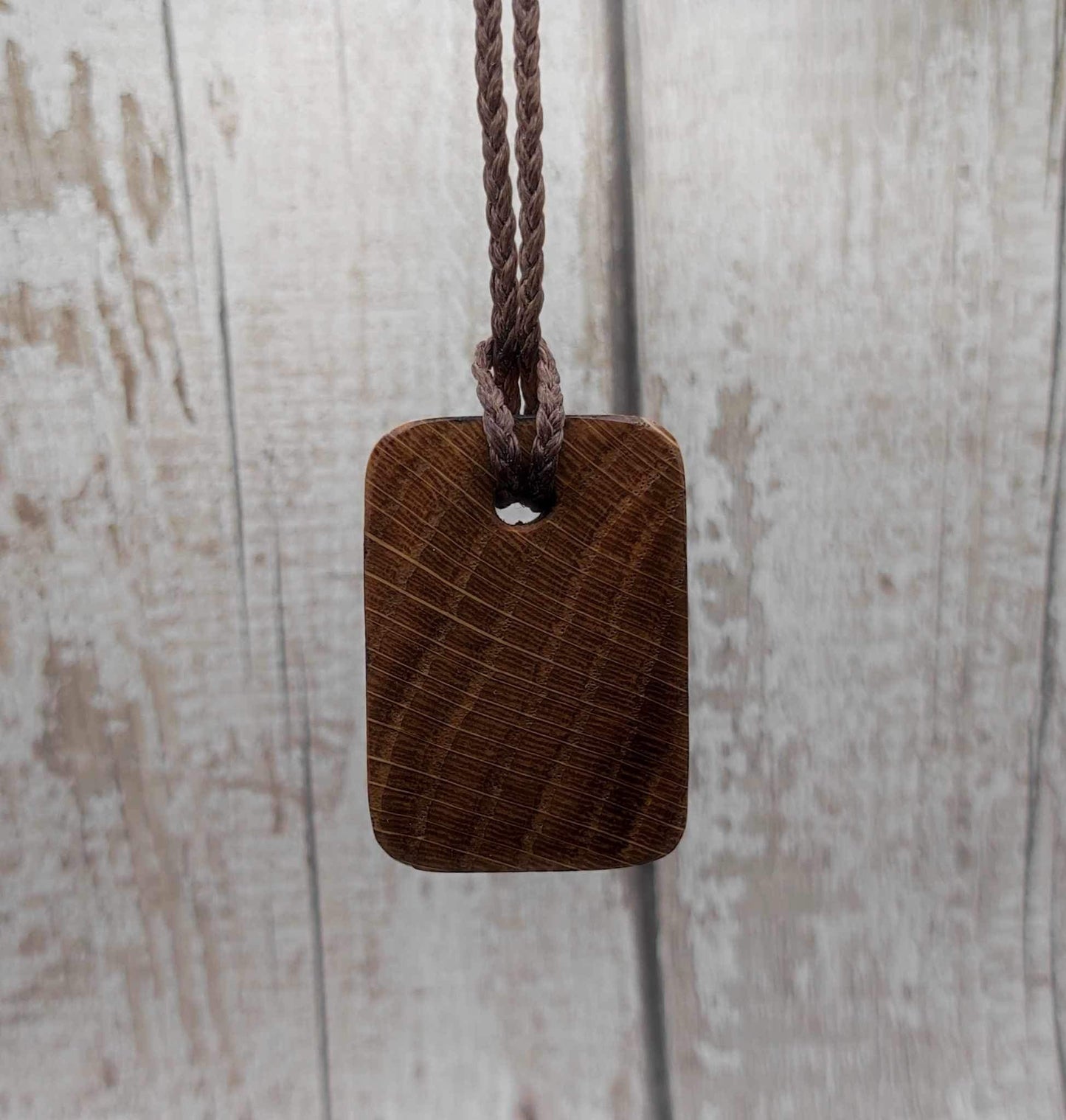 Wunjo oak wood rune pendant with mussel shell inlay.