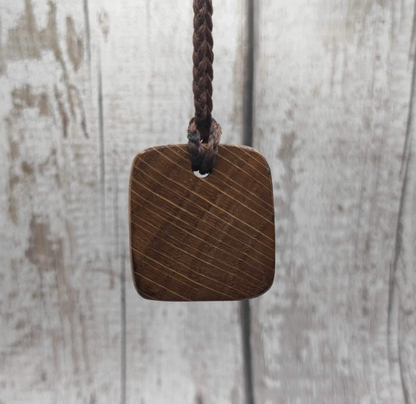 Nauthiz oak rune pendant with blue kyanite inlay.
