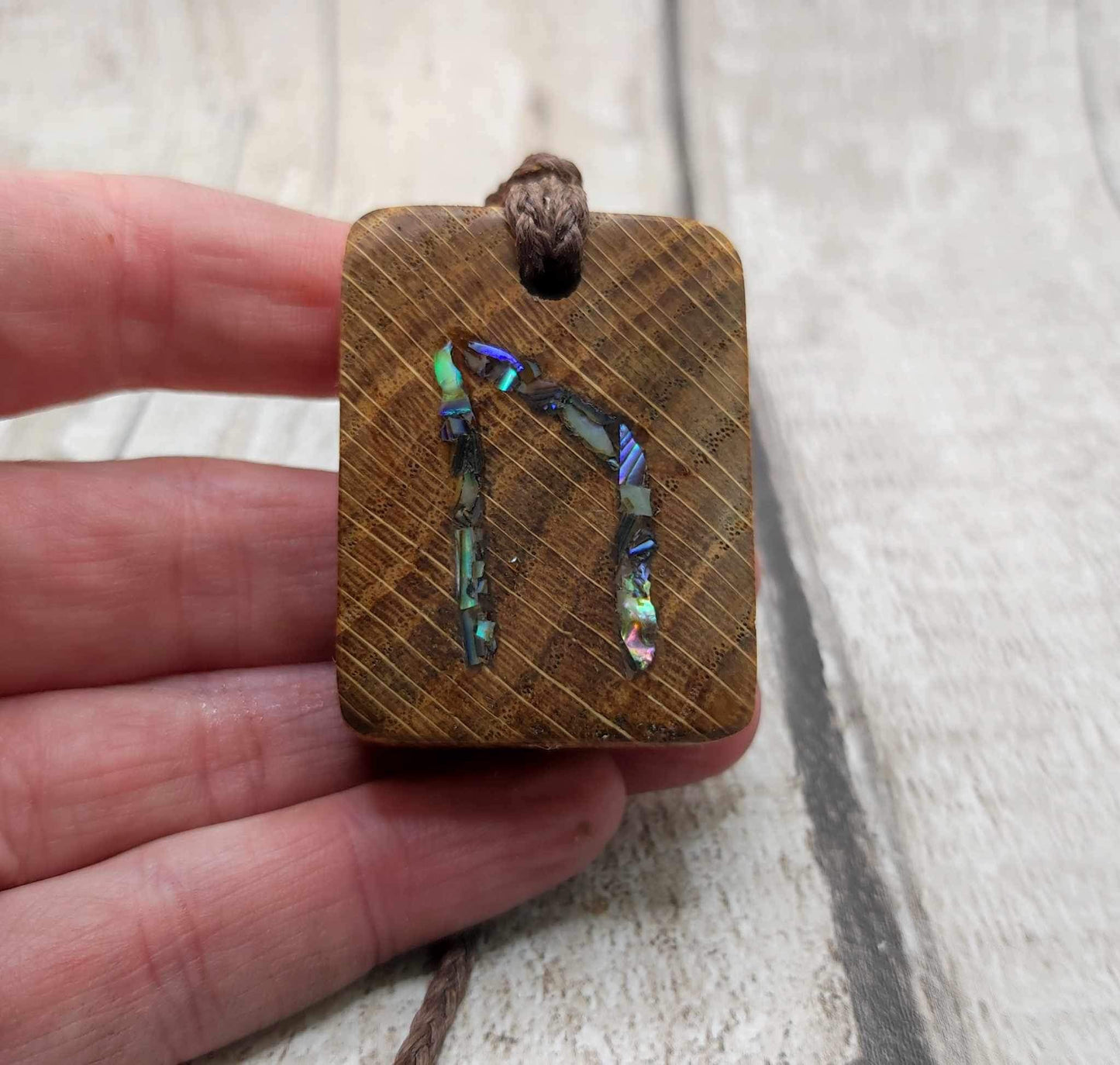 Oak wood Uruz rune pendant with Pāua shell.