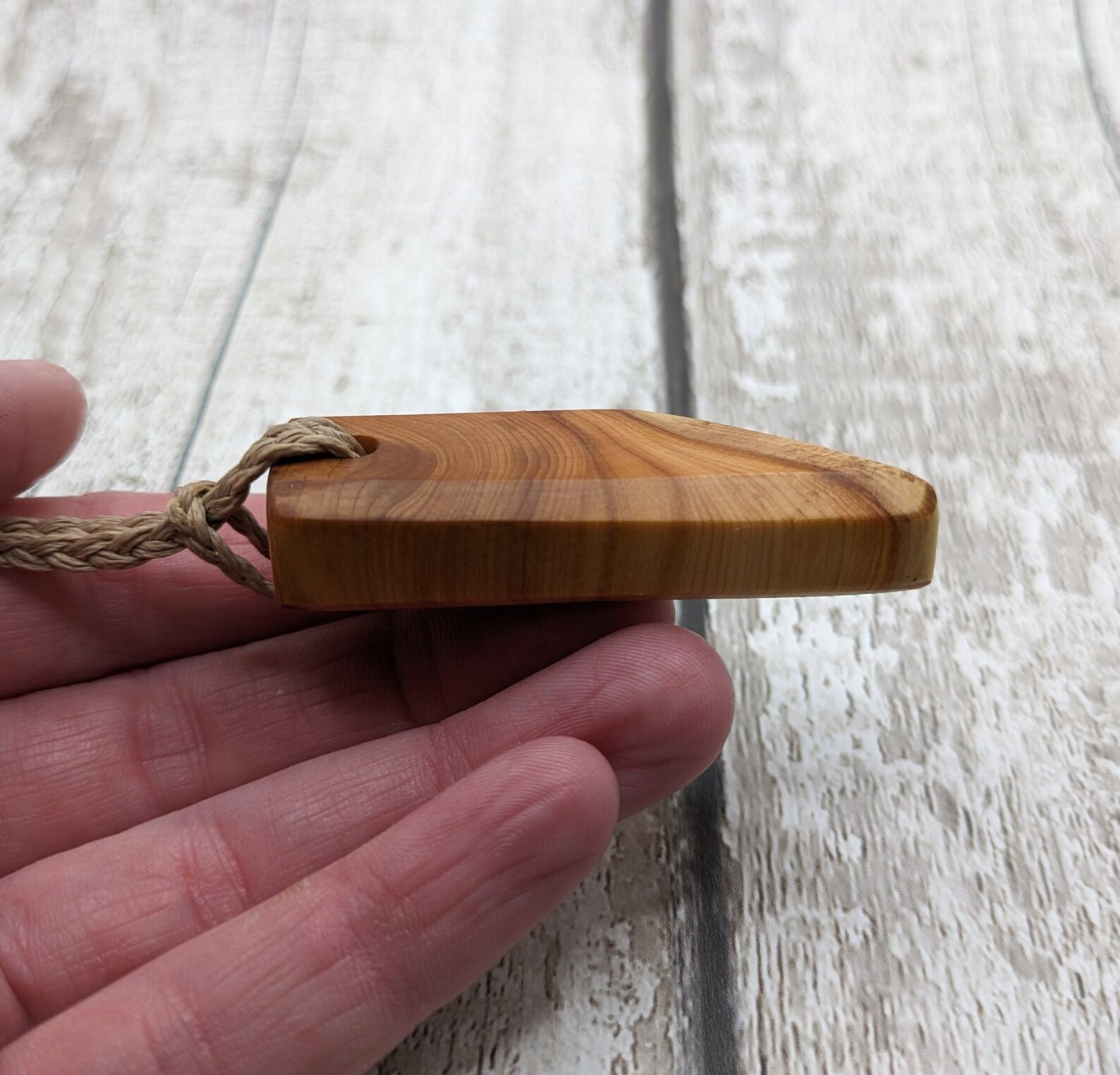 Faceted yew wood slice pendant.