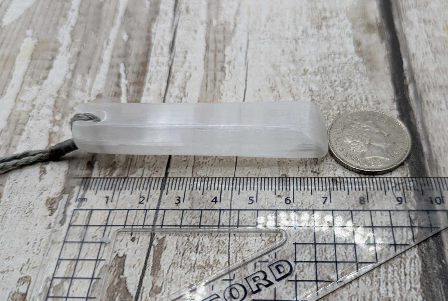 Selenite satin spar Toki pendant.