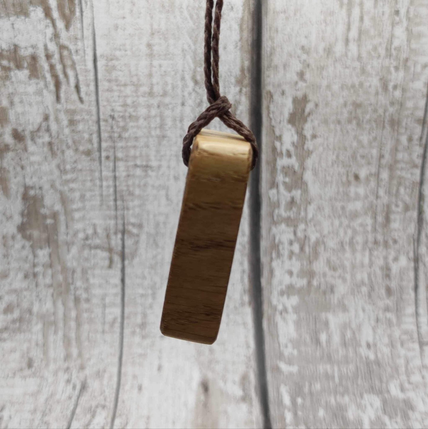 Oak wood Fehu rune Christmas decorations with rainbow Pāua.