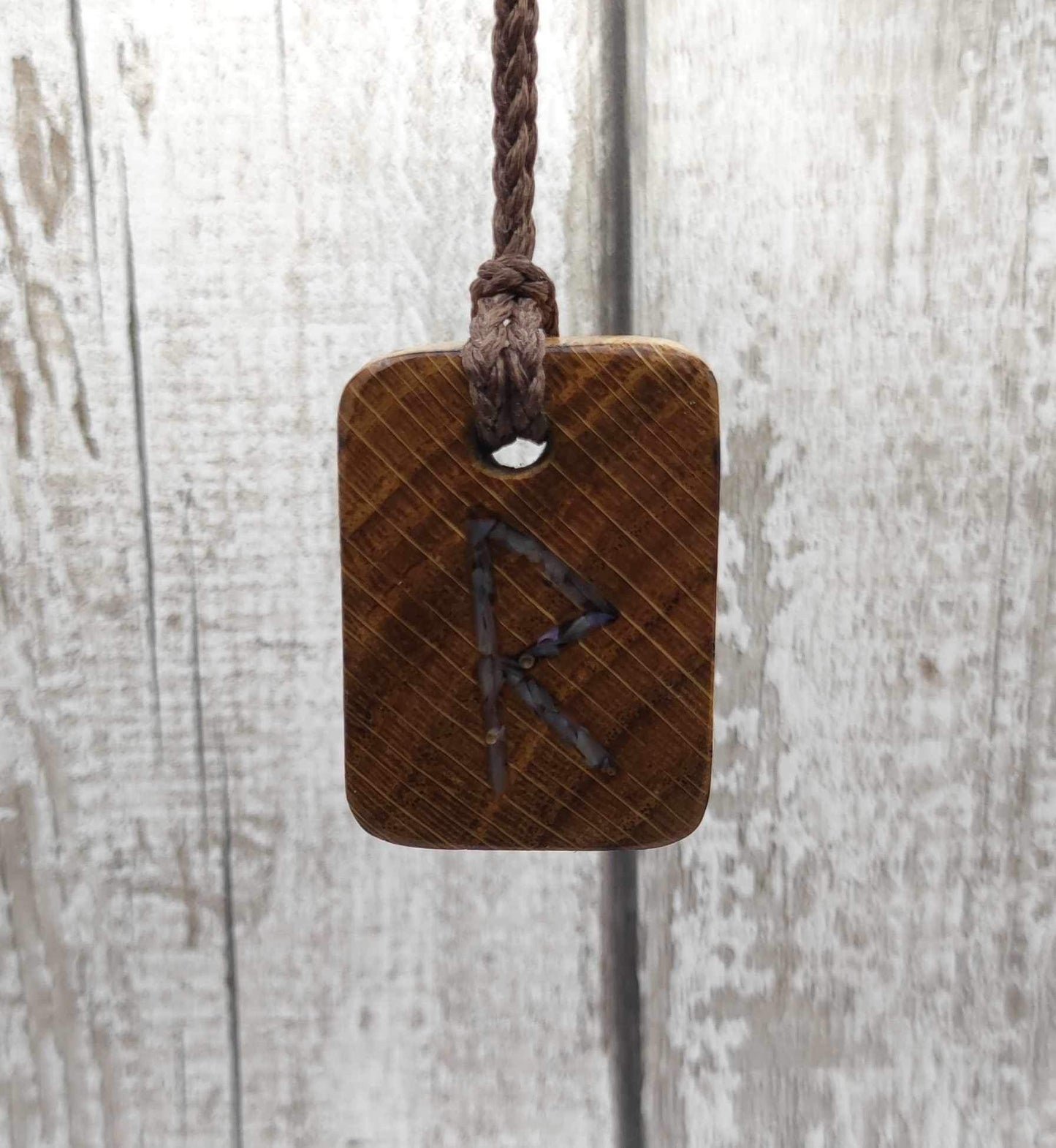 Raidho oak wood rune pendant with mussel shell inlay.