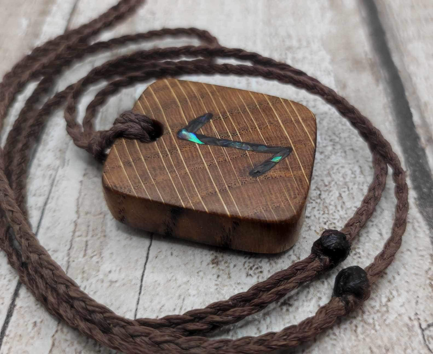 Eihwaz oak wood rune pendant with Pāua shell inlay.