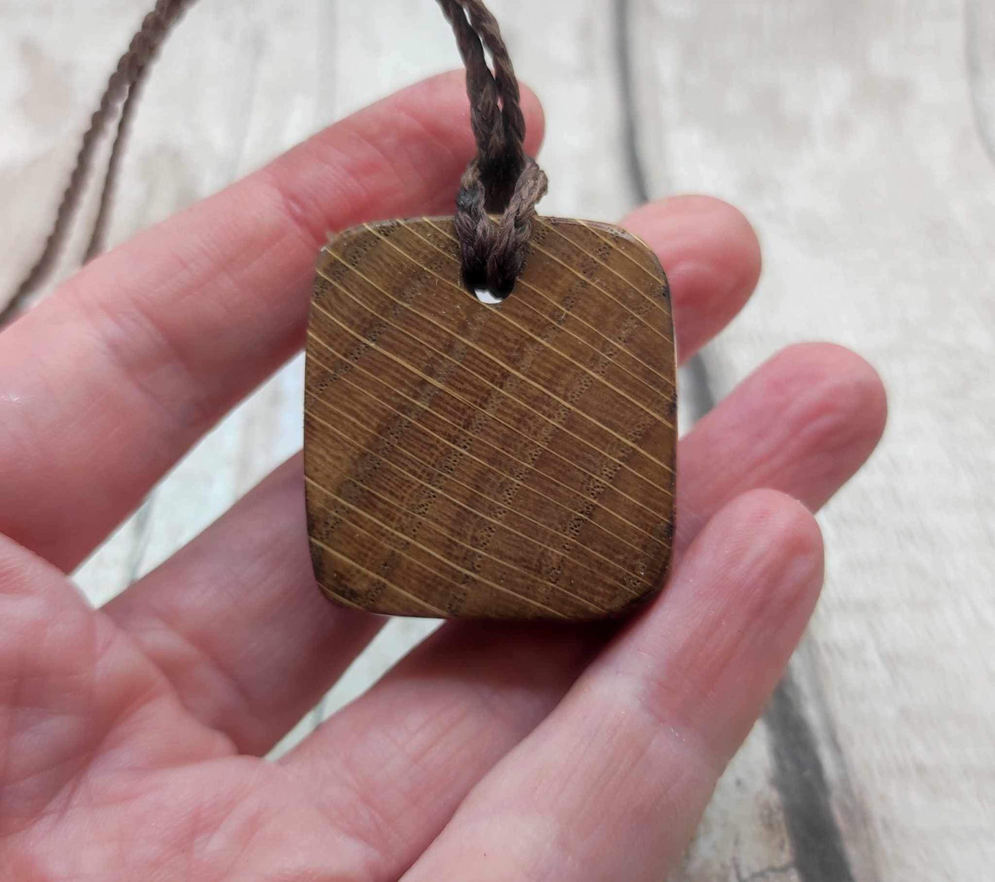 Nauthiz oak rune pendant with blue kyanite inlay.