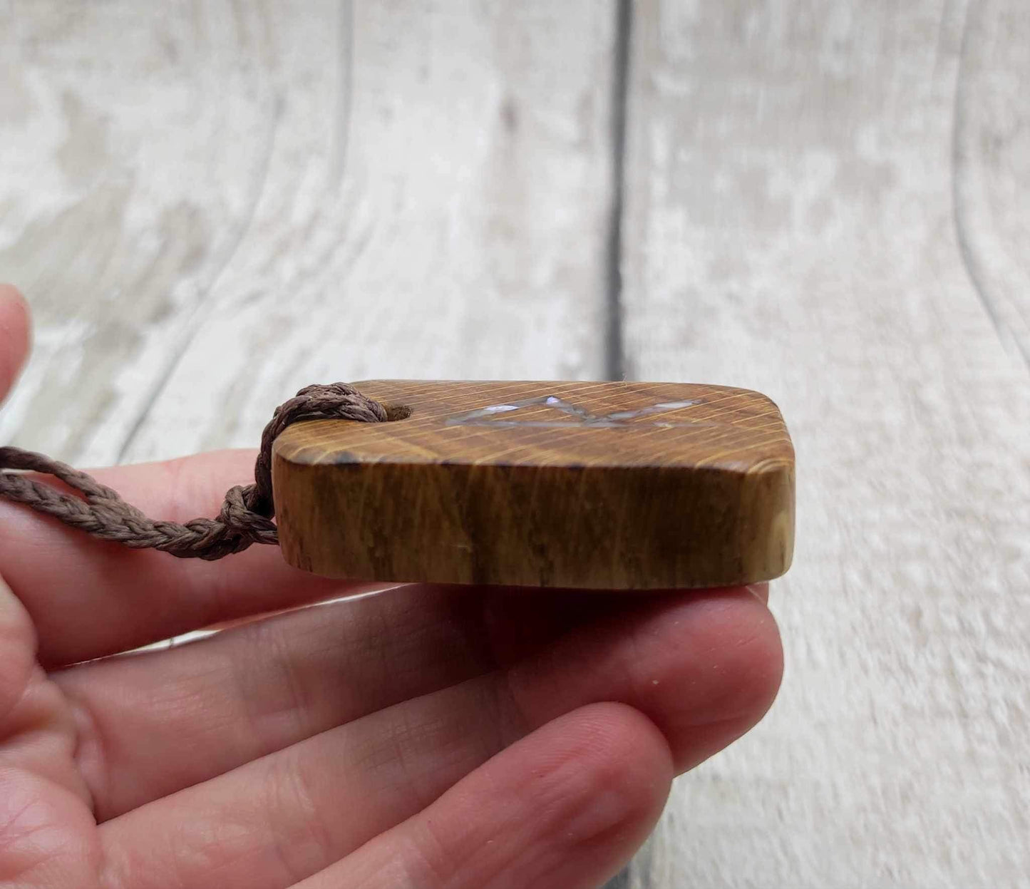 Raidho oak wood rune pendant with mussel shell inlay.
