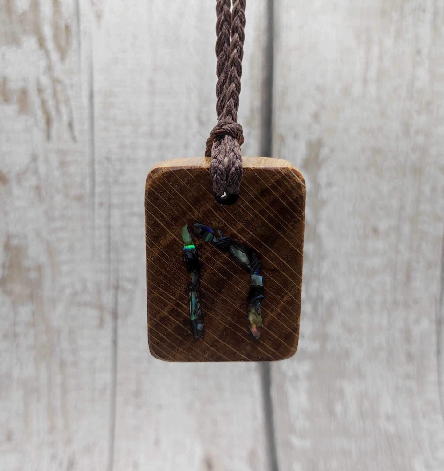Oak wood Uruz rune pendant with Pāua shell.