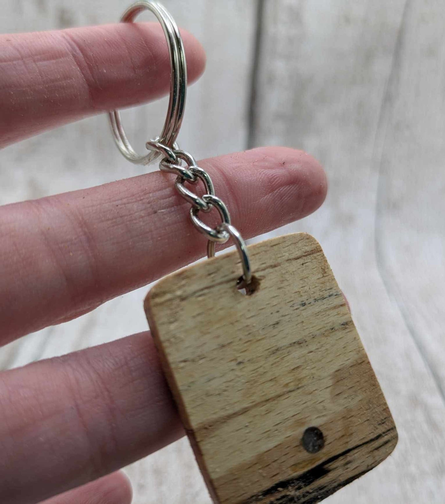 Beech wood keyring with blue kyanite inlay.