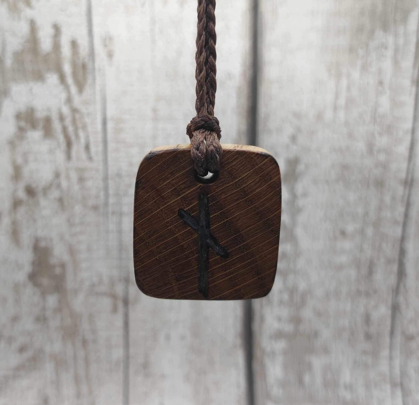 Nauthiz oak rune pendant with blue kyanite inlay.