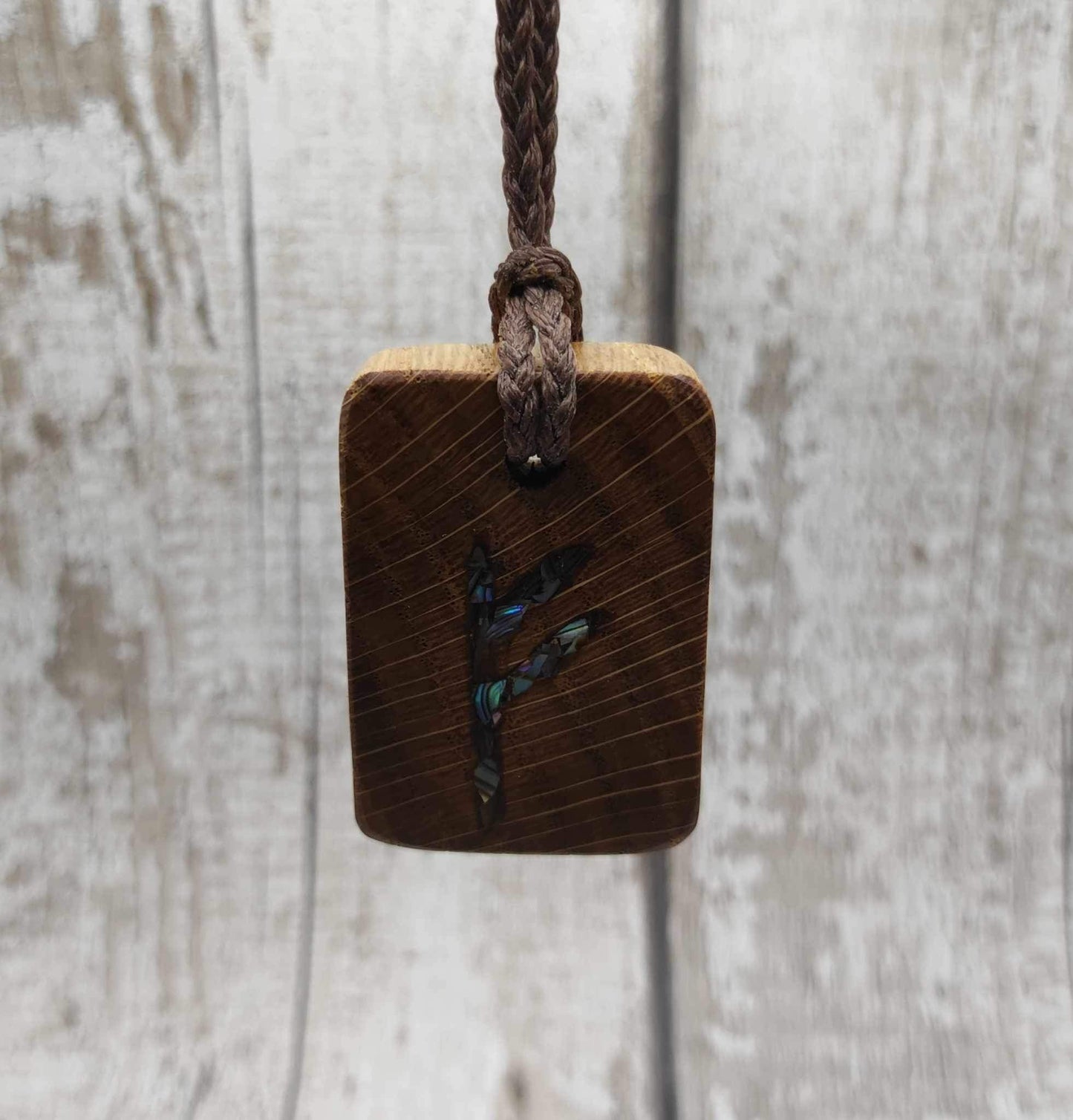 Oak wood Fehu rune Christmas decorations with rainbow Pāua.