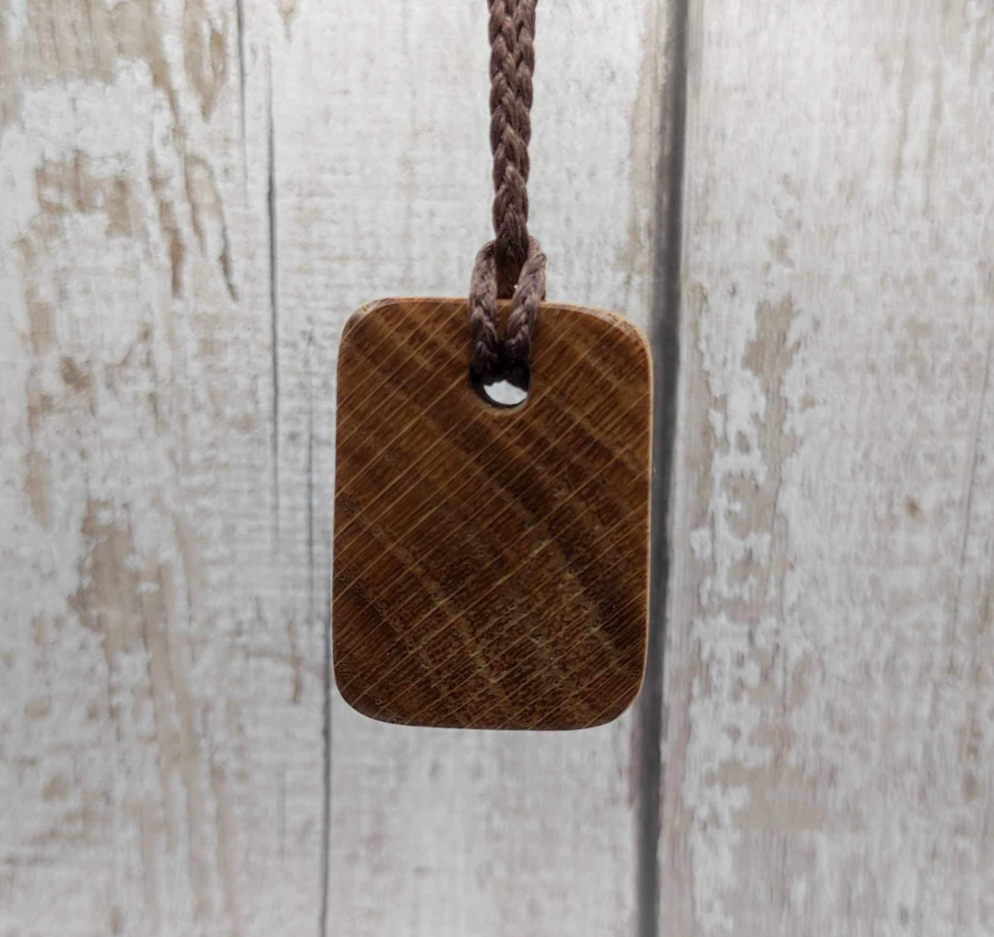 Raidho oak wood rune pendant with mussel shell inlay.