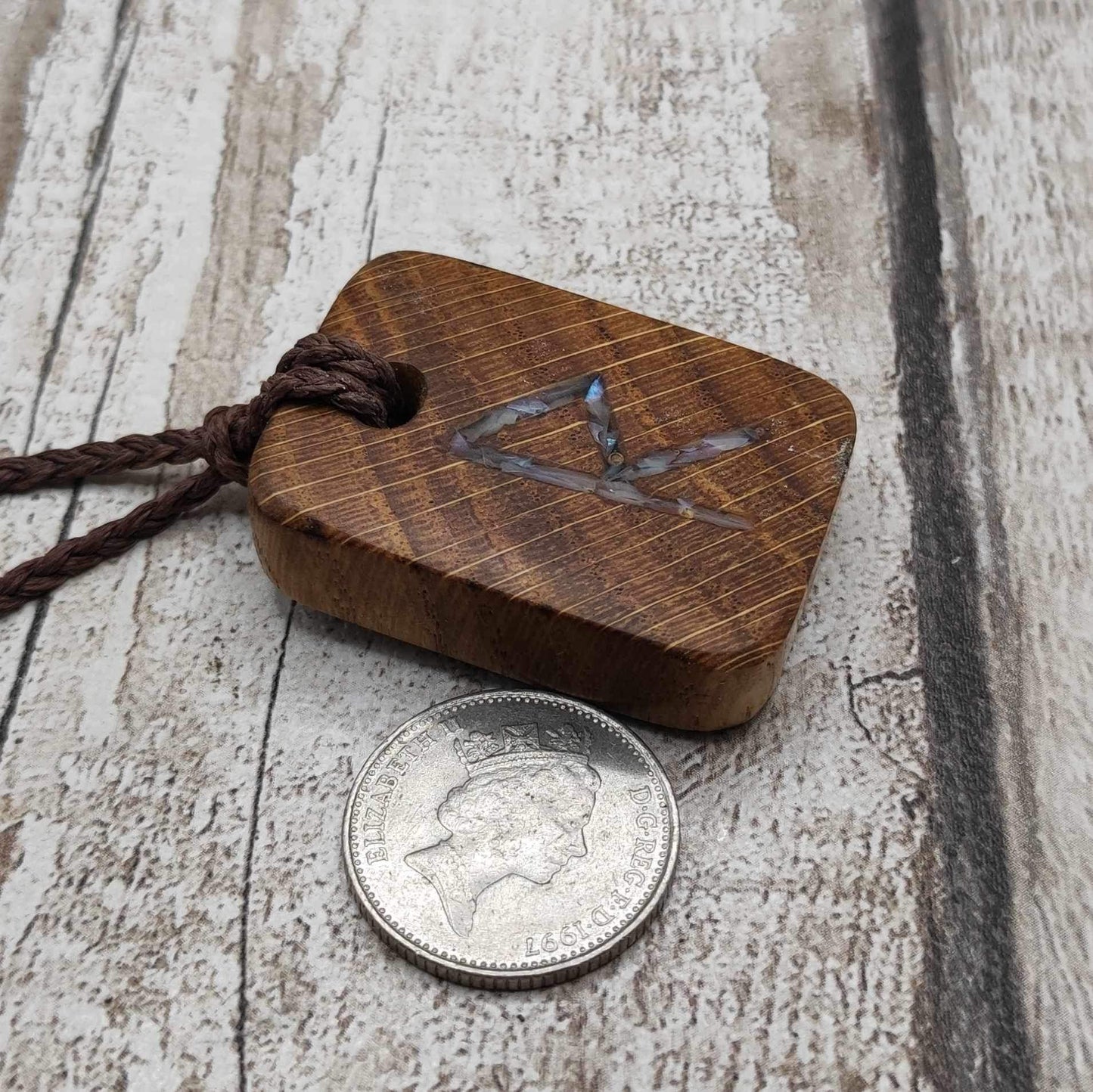 Raidho oak wood rune pendant with mussel shell inlay.