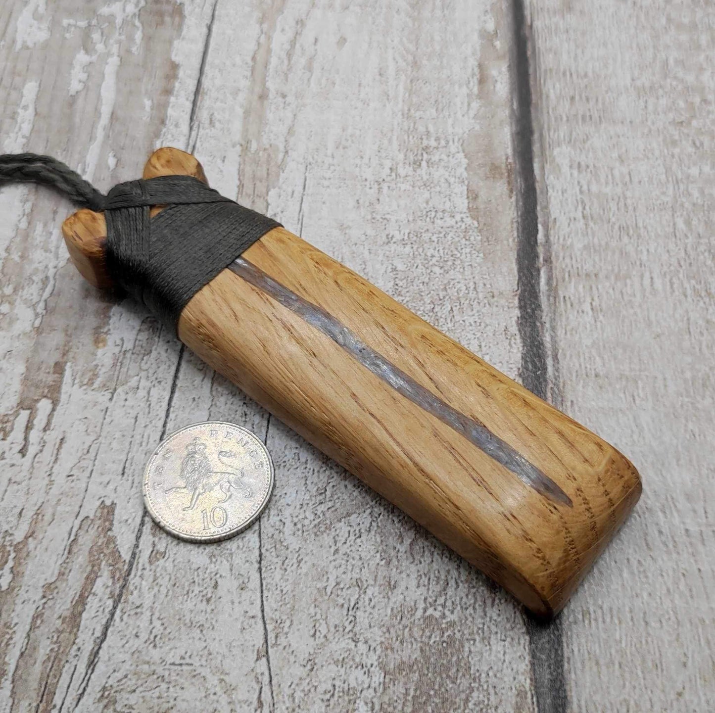 Oak wood statement Hei Toki adze pendant with blue kyanite inlay.