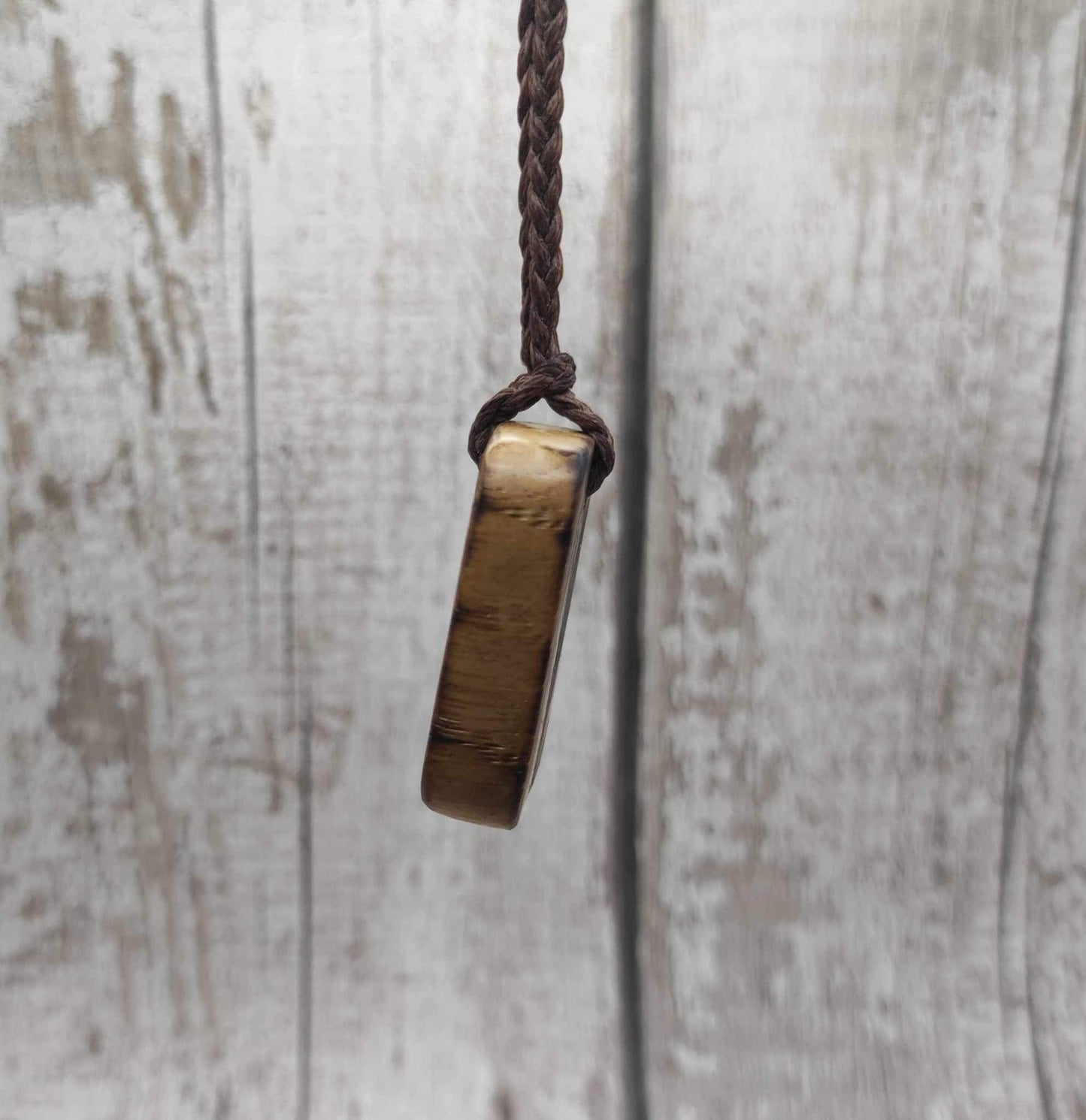 Nauthiz oak rune pendant with blue kyanite inlay.