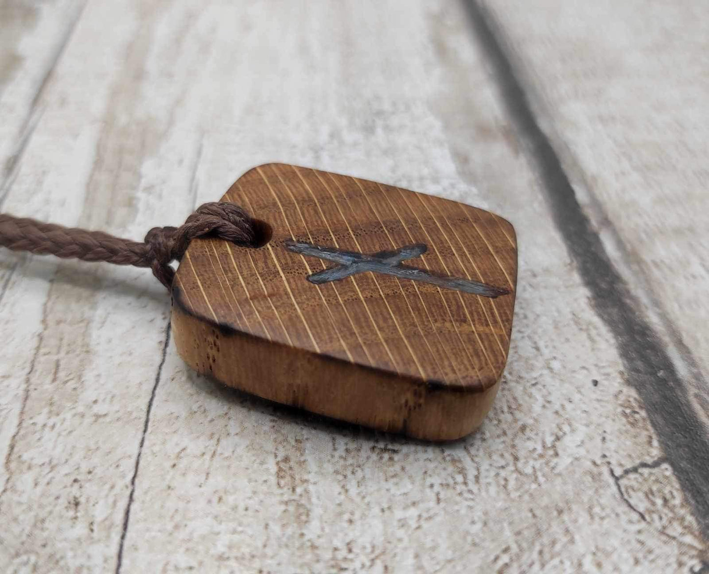 Nauthiz oak rune pendant with blue kyanite inlay.