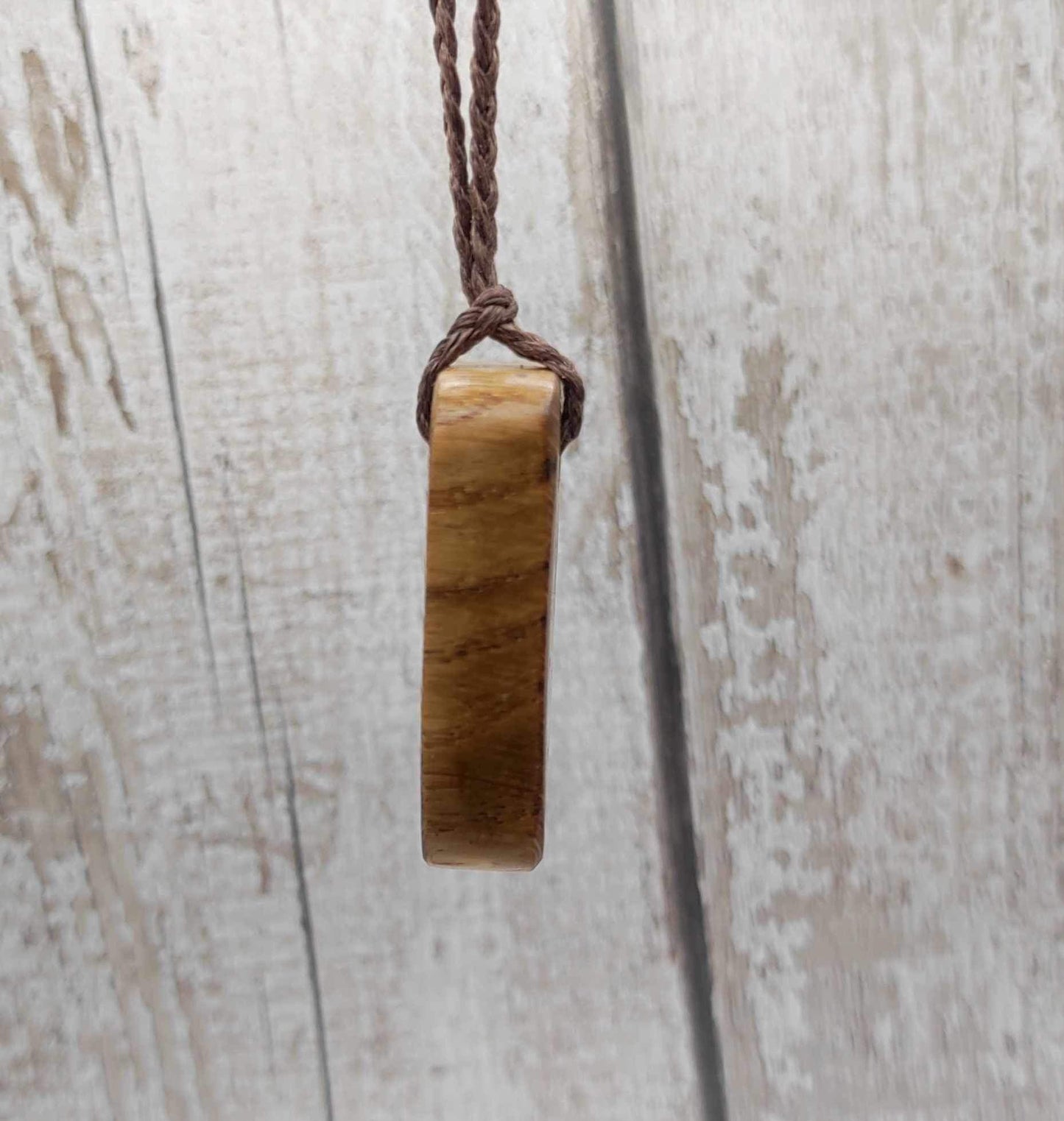 Raidho oak wood rune pendant with mussel shell inlay.