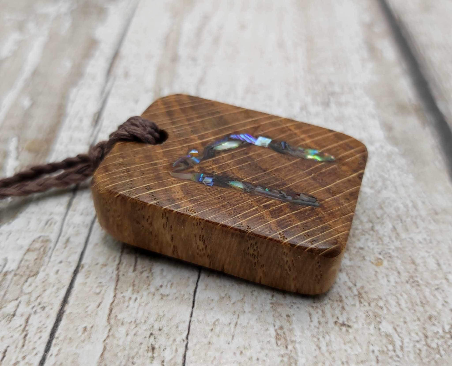 Oak wood Uruz rune pendant with Pāua shell.
