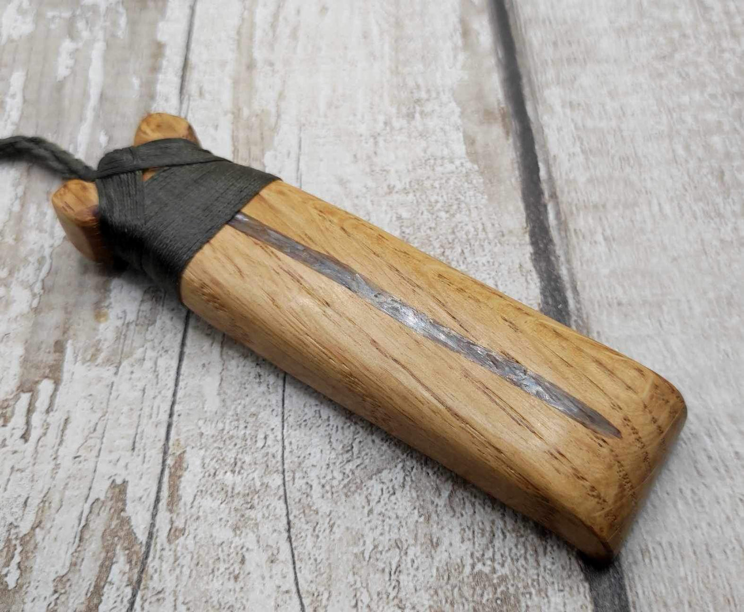 Oak wood statement Hei Toki adze pendant with blue kyanite inlay.