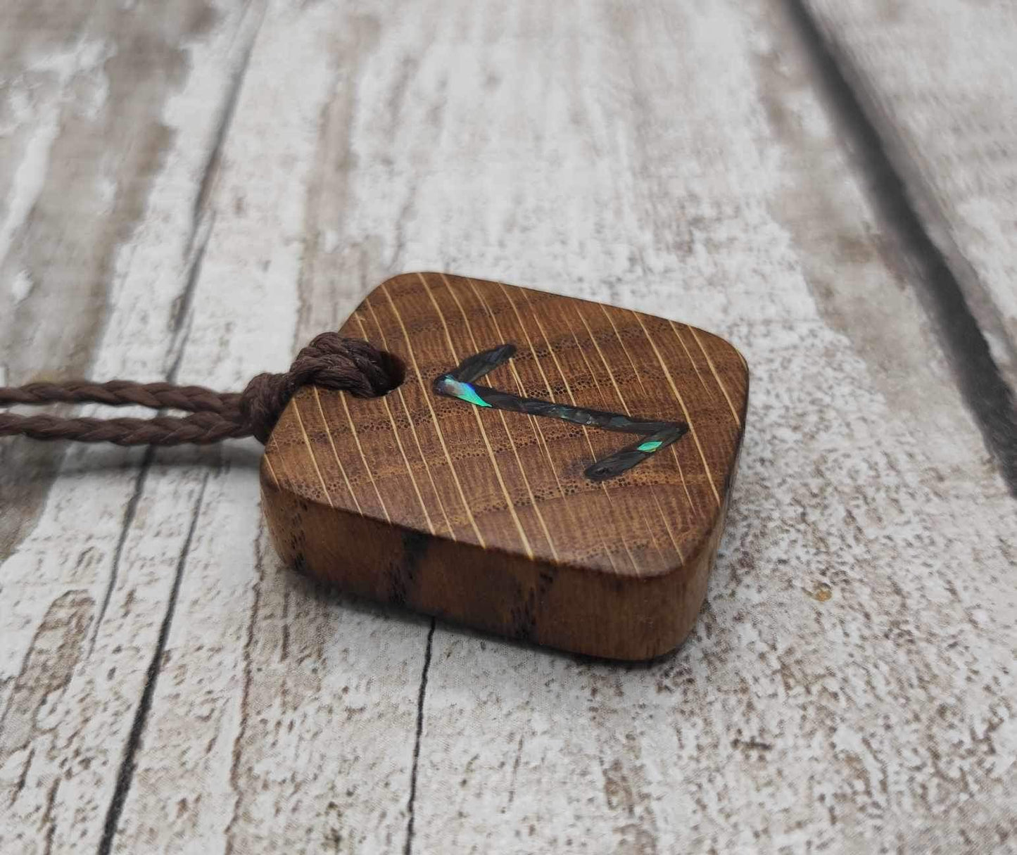 Eihwaz oak wood rune pendant with Pāua shell inlay.