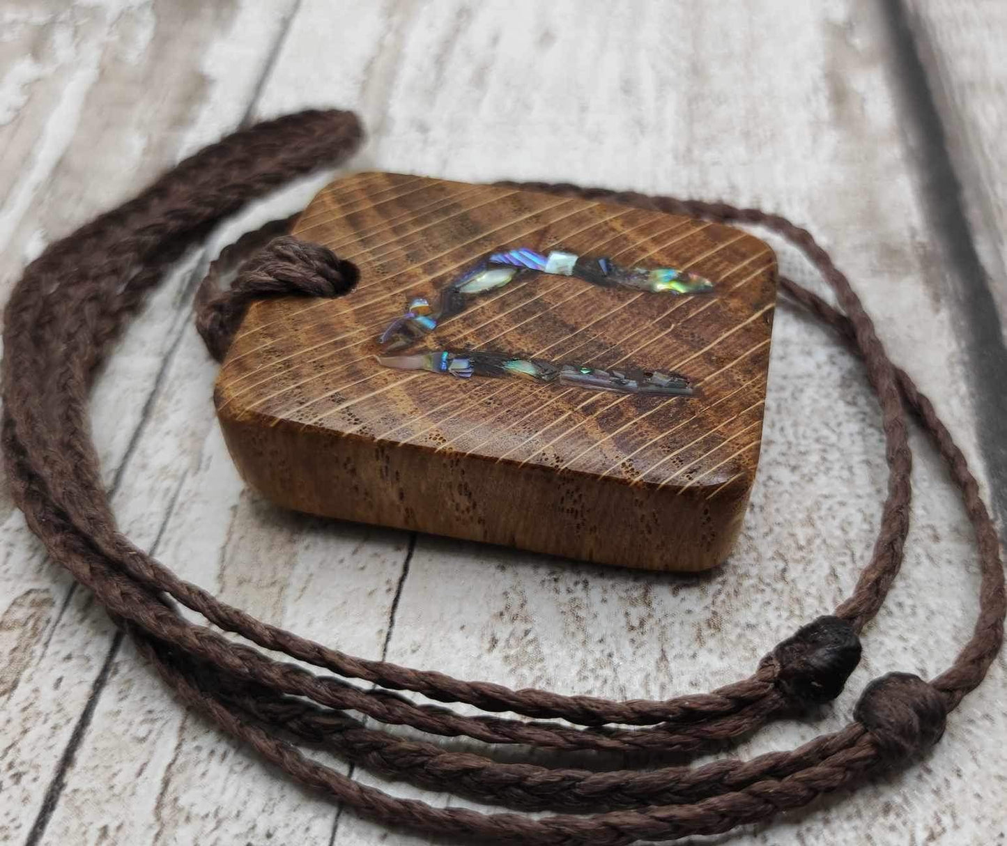 Oak wood Uruz rune pendant with Pāua shell.