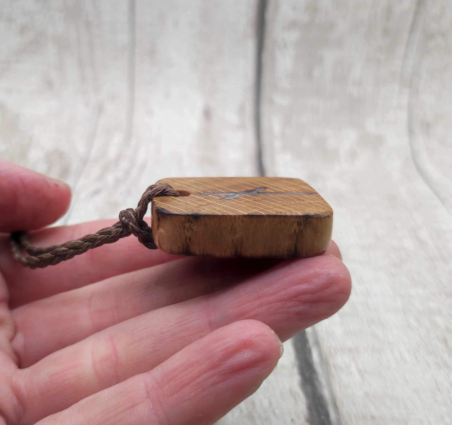 Nauthiz oak rune pendant with blue kyanite inlay.