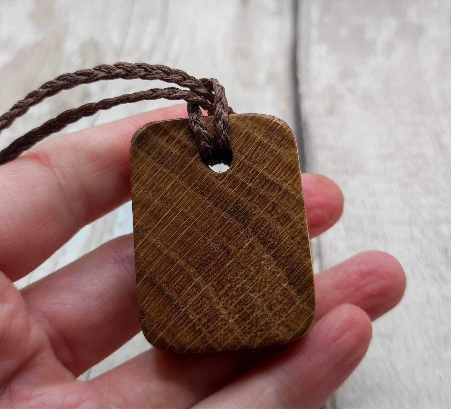 Raidho oak wood rune pendant with mussel shell inlay.