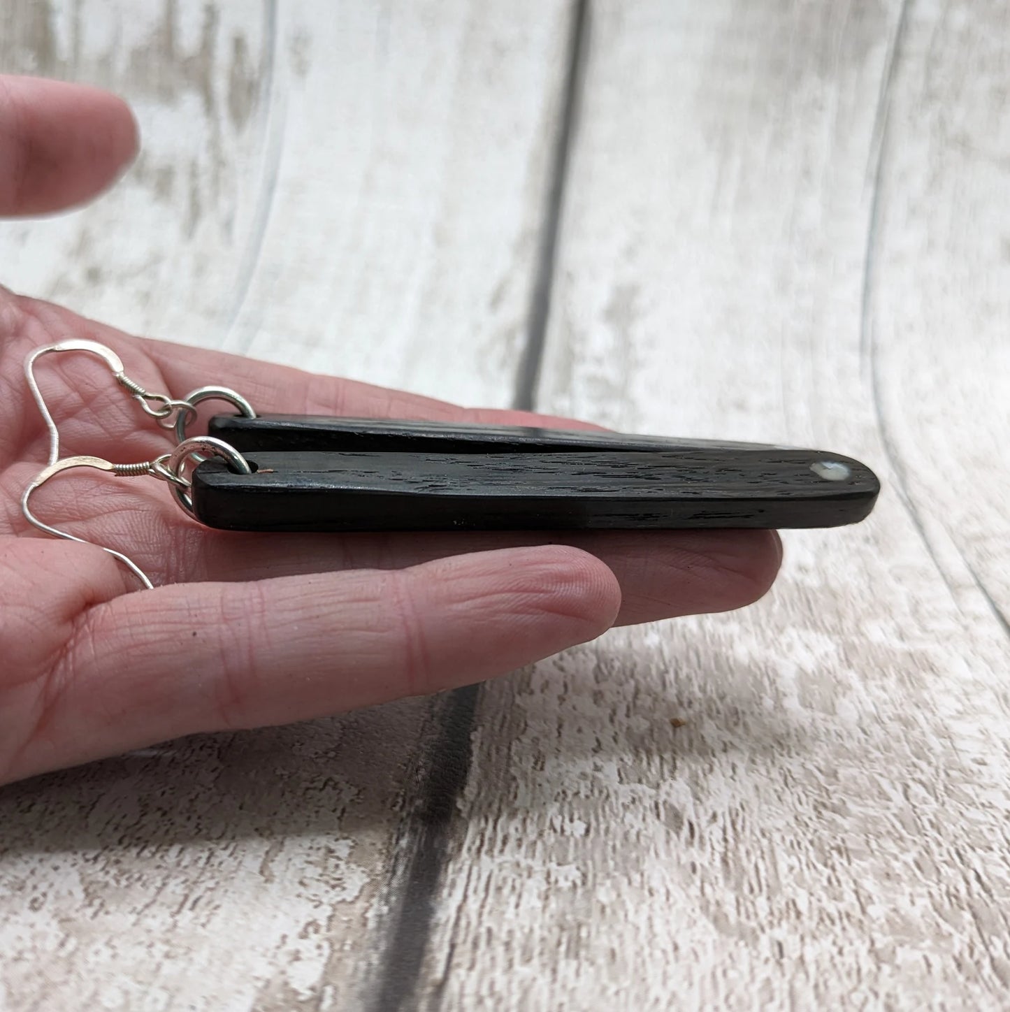 Fenland bog oak roimata drop earrings with mussel shell inlay.