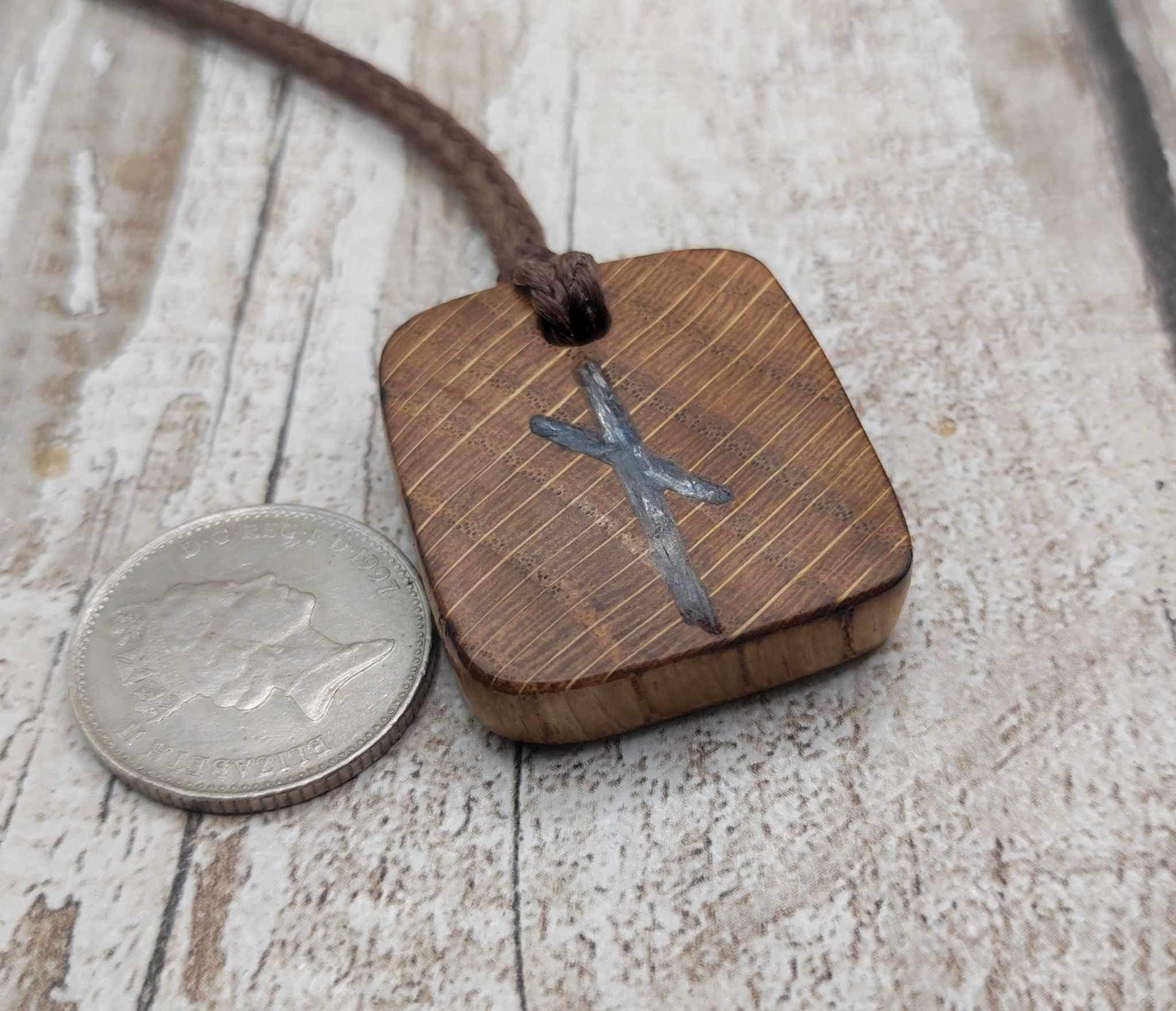Nauthiz oak rune pendant with blue kyanite inlay.