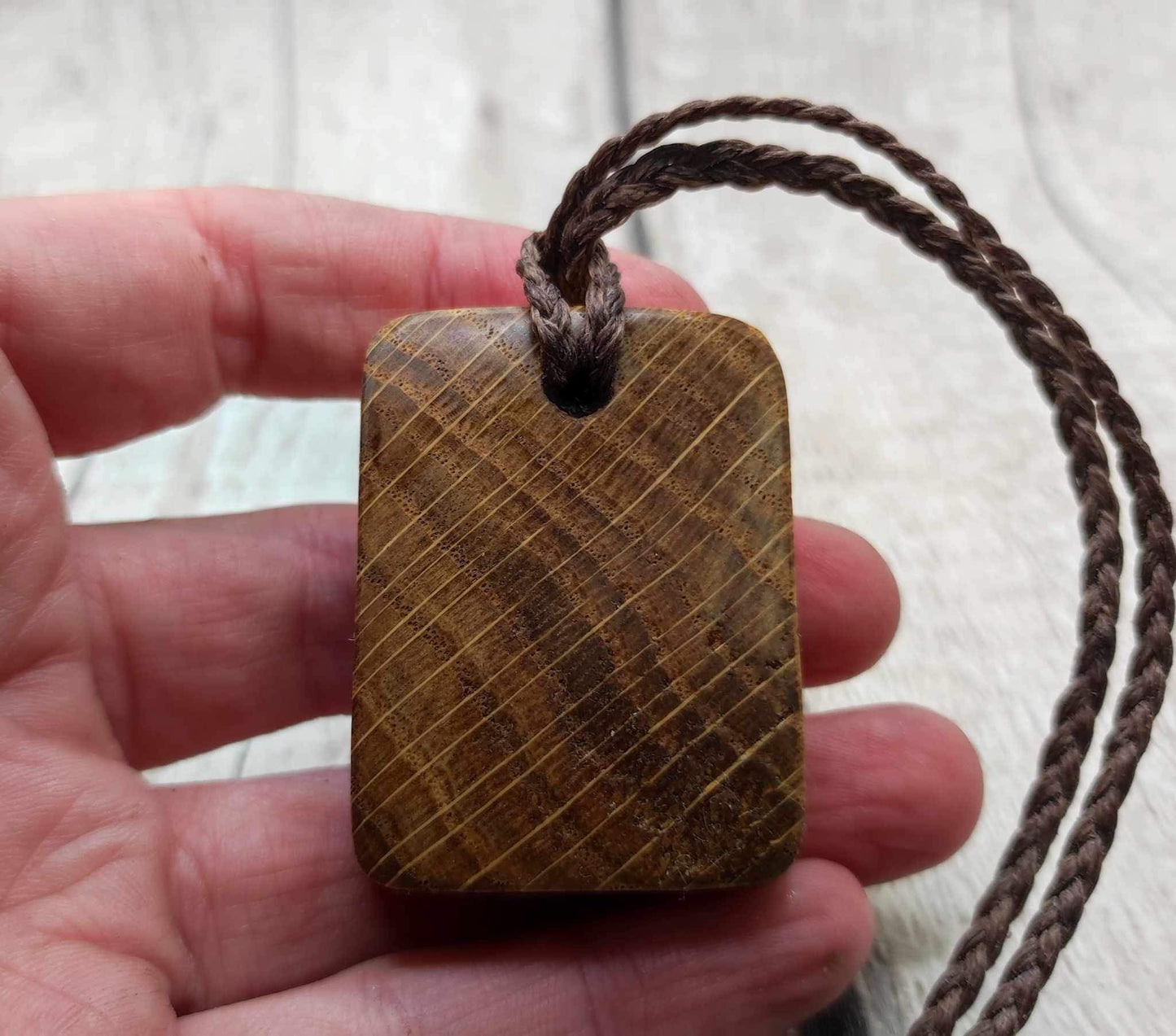 Oak wood Uruz rune pendant with Pāua shell.