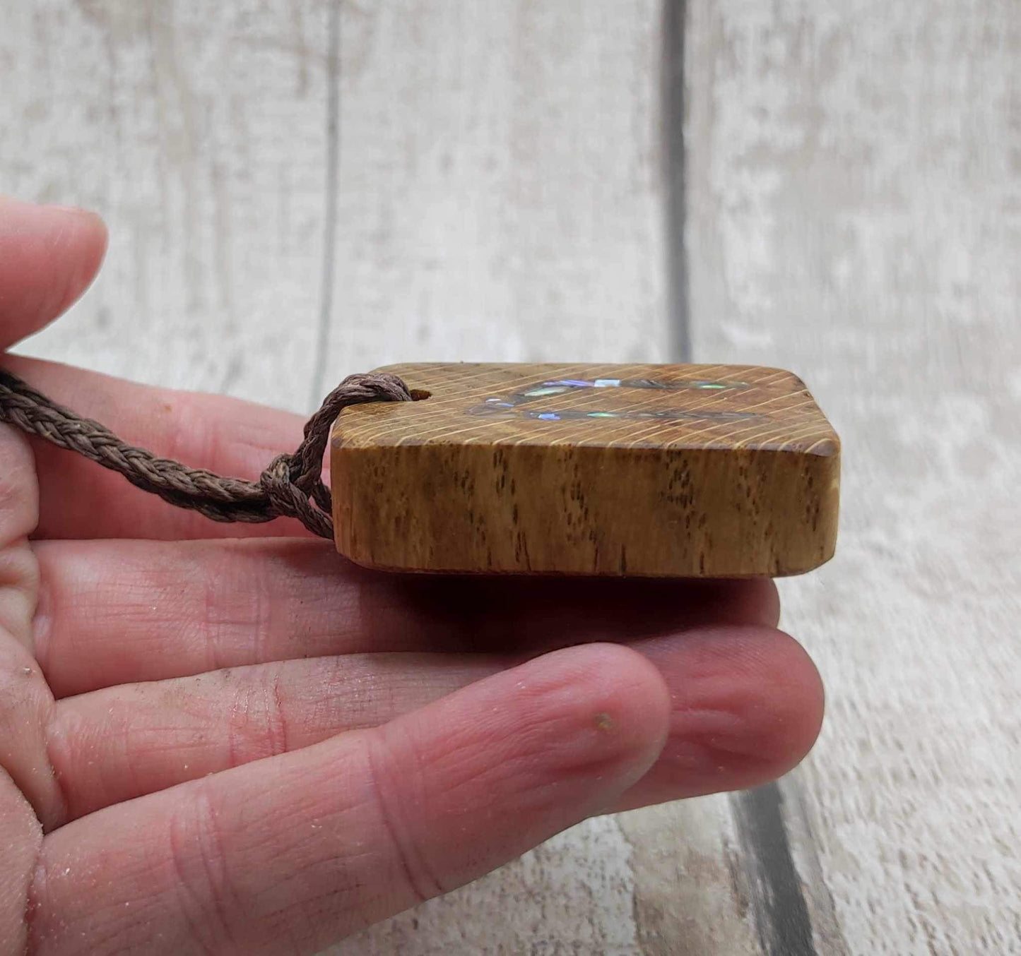 Oak wood Uruz rune pendant with Pāua shell.