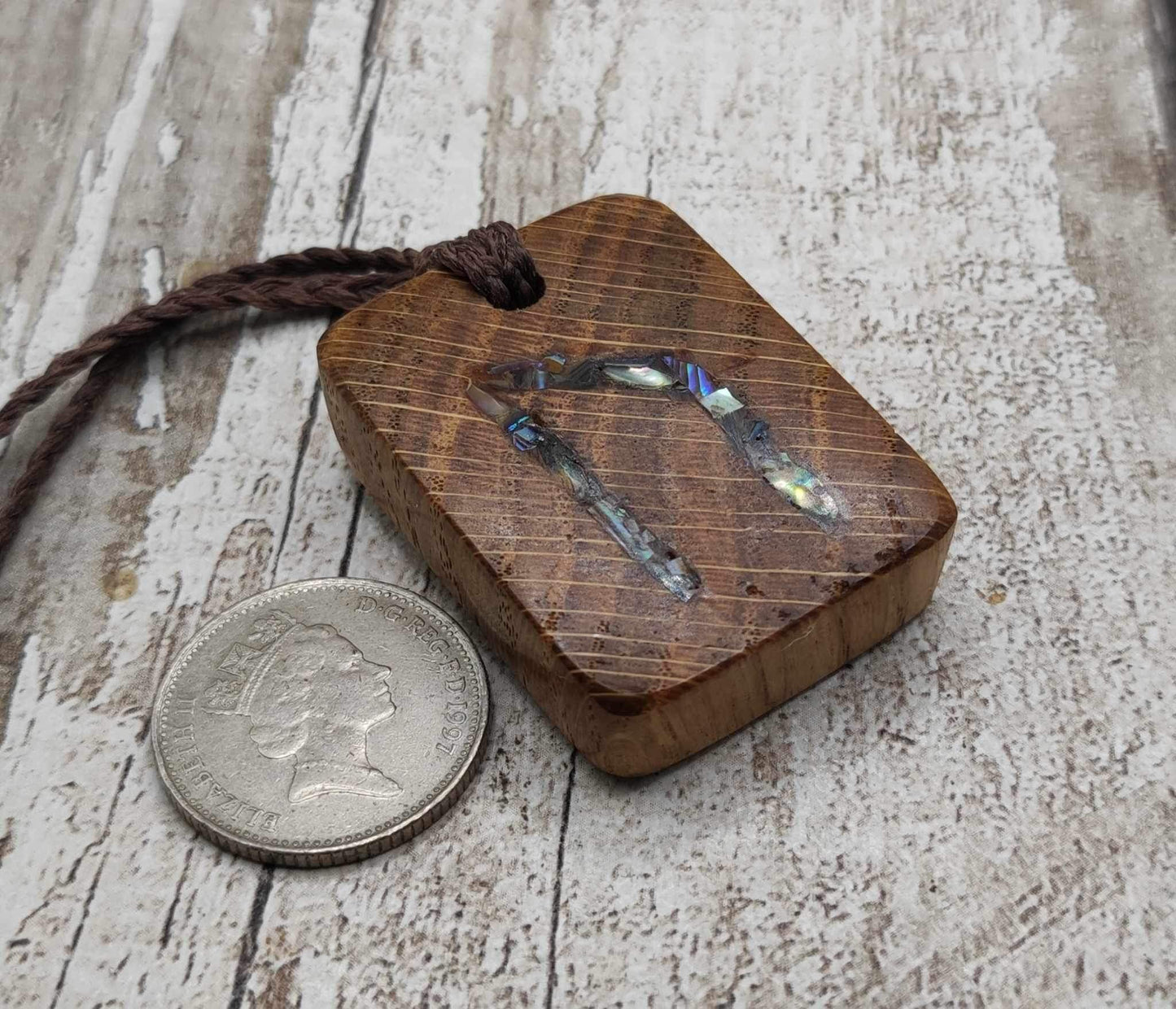 Oak wood Uruz rune pendant with Pāua shell.