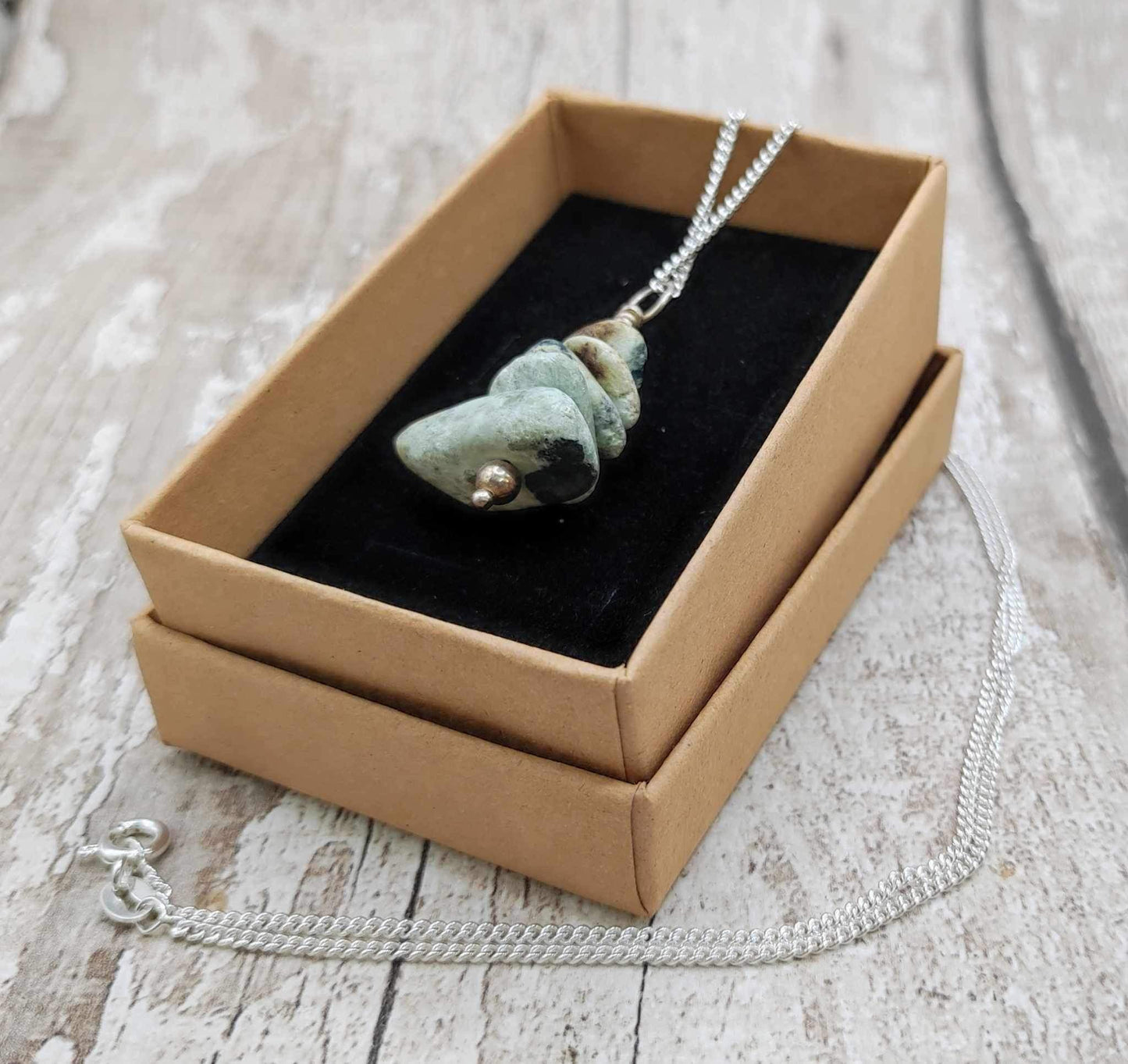 New Zealand pounamu Greenstone tumbled stone bead pendant.