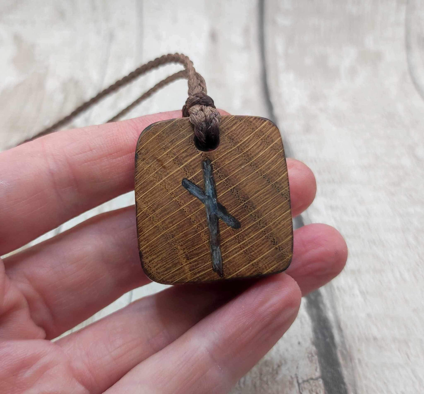 Nauthiz oak rune pendant with blue kyanite inlay.
