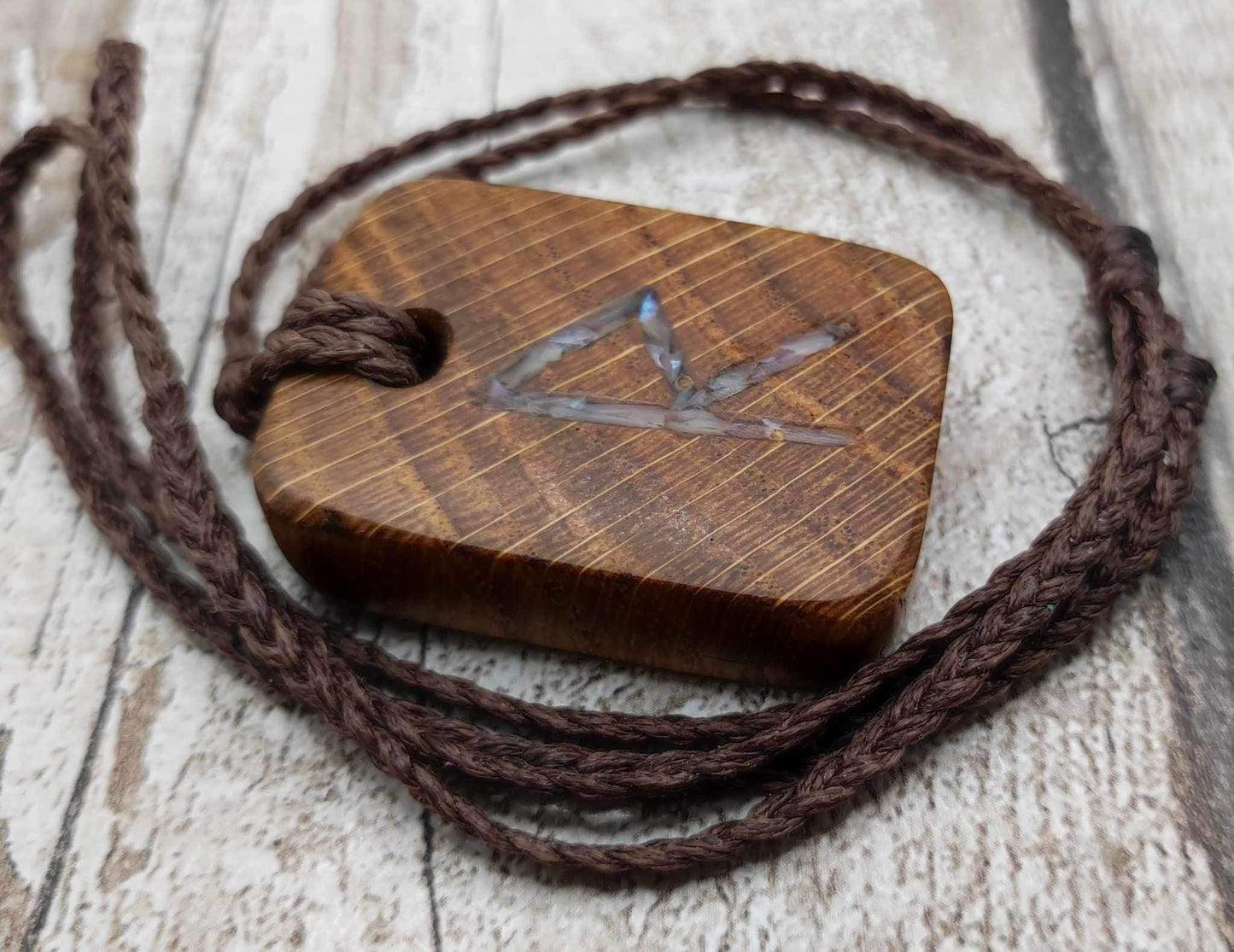 Raidho oak wood rune pendant with mussel shell inlay.