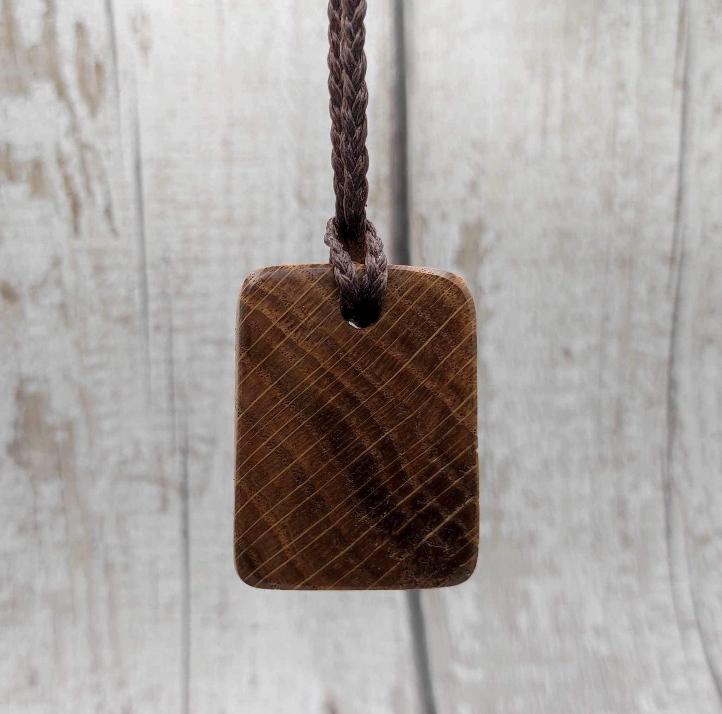 Oak wood Uruz rune pendant with Pāua shell.