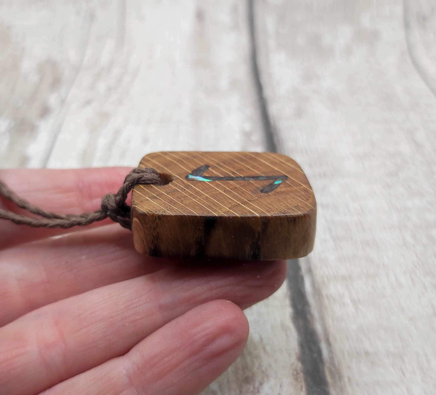 Eihwaz oak wood rune pendant with Pāua shell inlay.