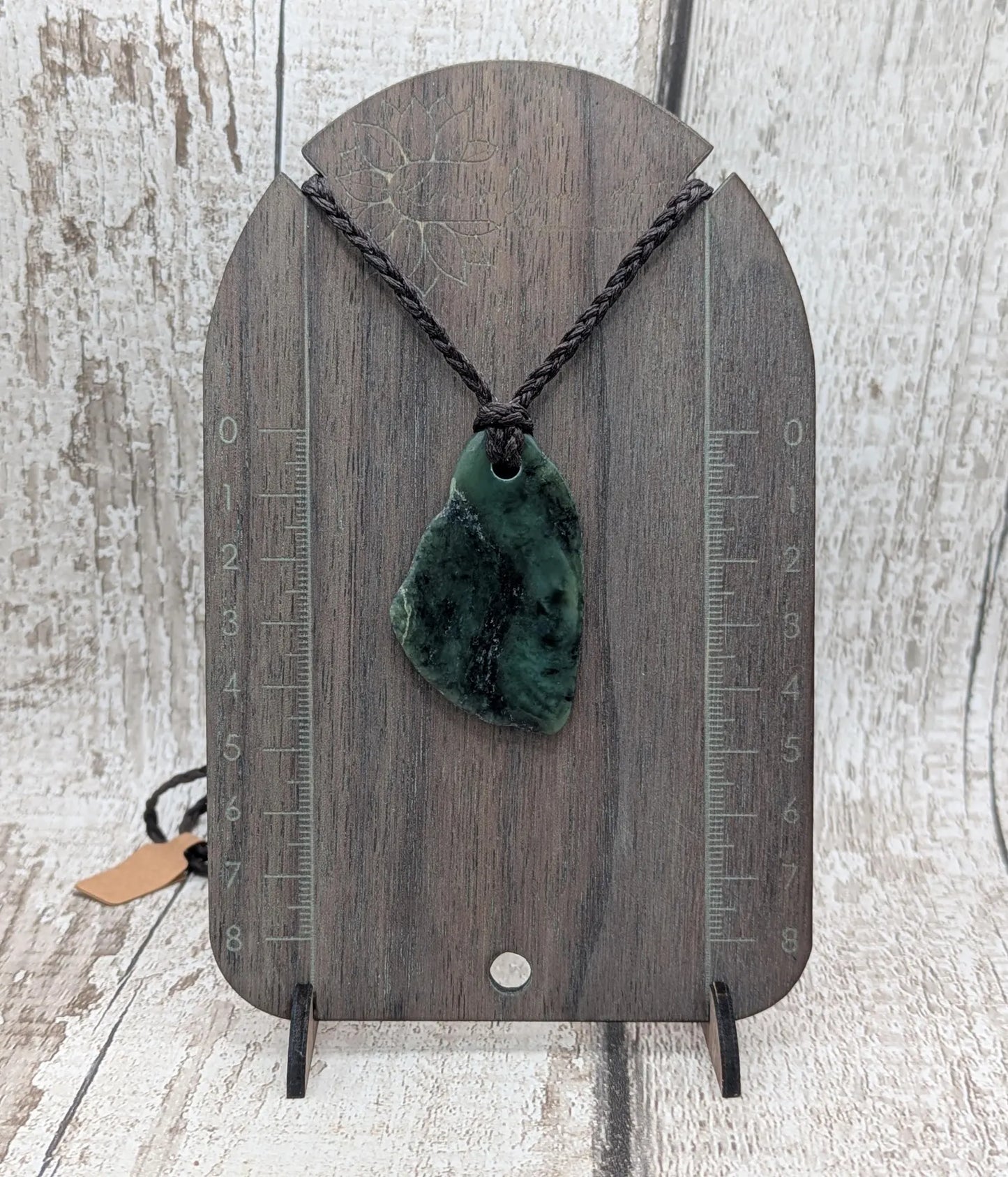 Tumbled New Zealand nephrite jade Pounamu pendant.