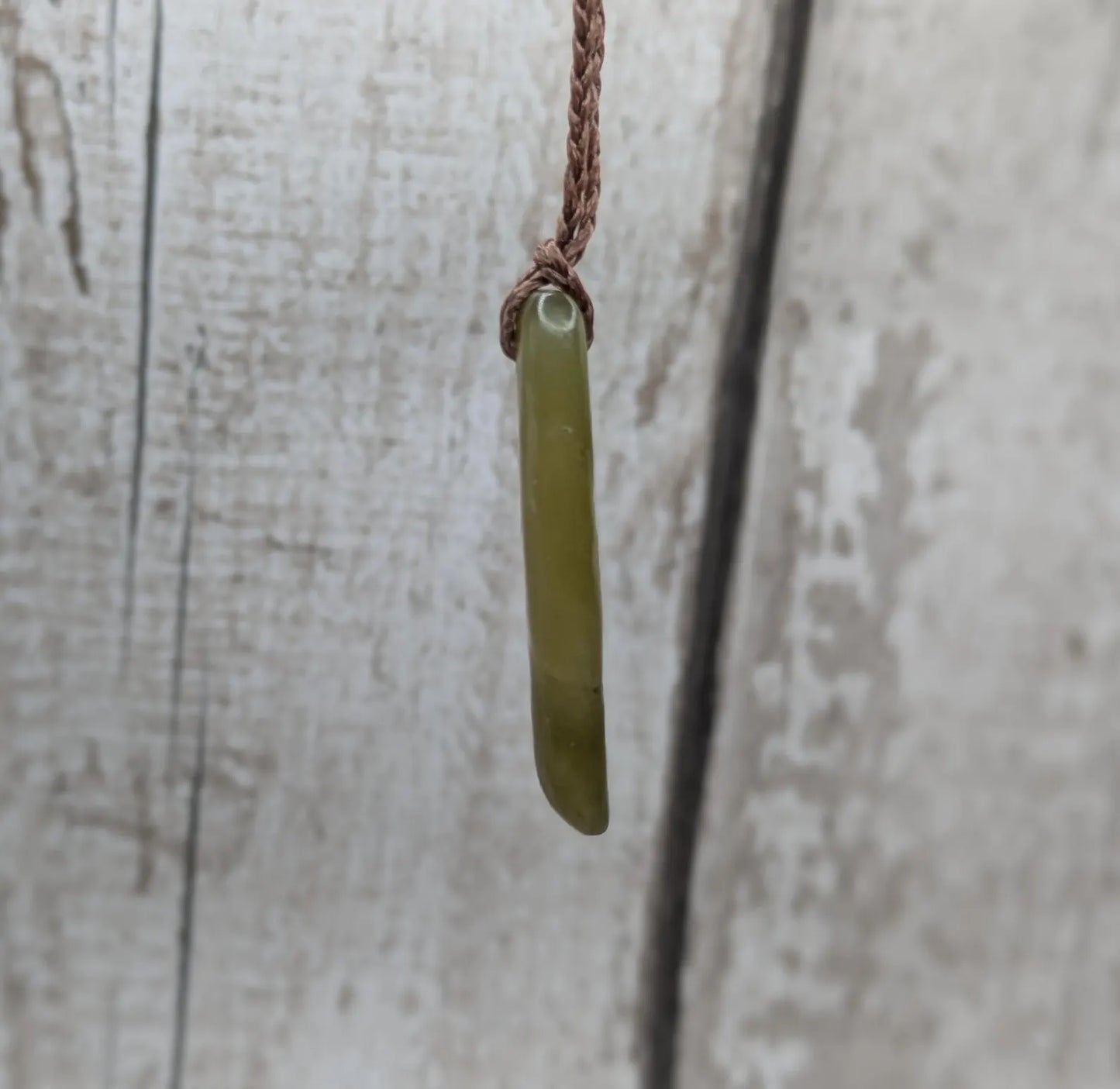 New Zealand tumbled Pounamu greenstone pendant.