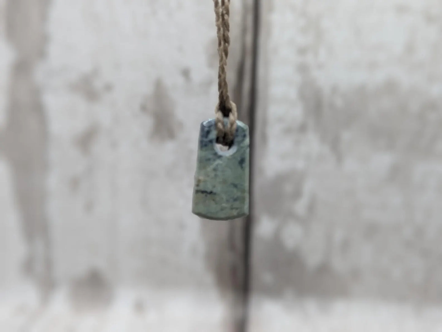 Tiny New Zealand greenstone jade roimata pendant.