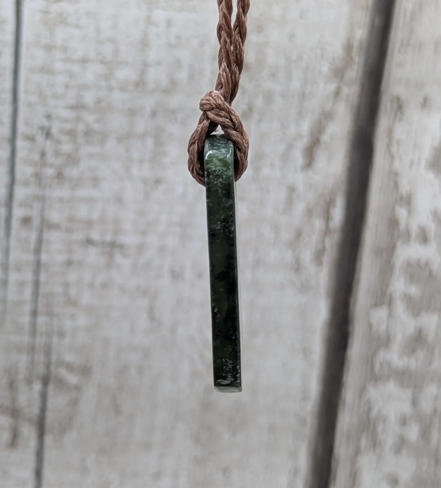 New Zealand Pounamu greenstone slice pendant.
