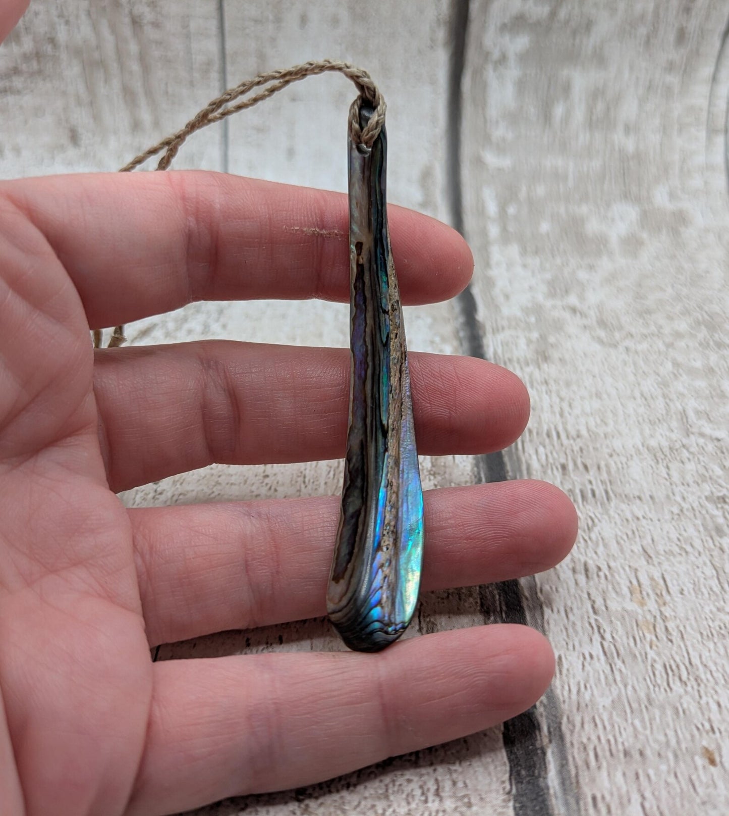 New Zealand rainbow pāua rim drop pendant.