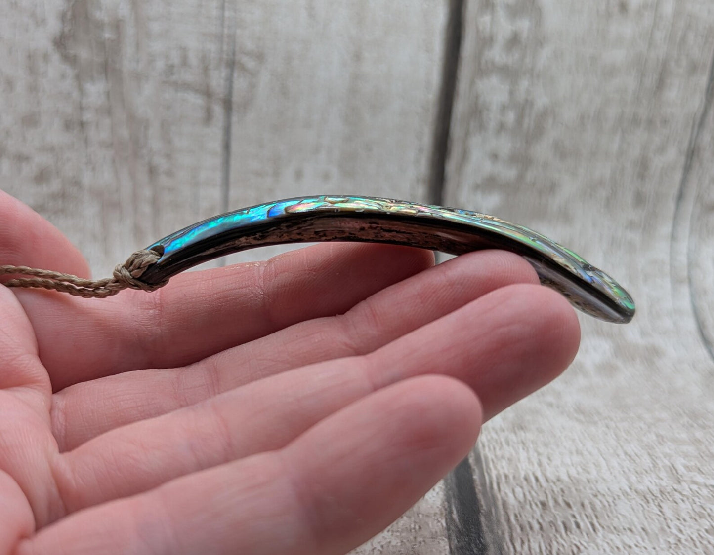 New Zealand rainbow pāua rim drop pendant.