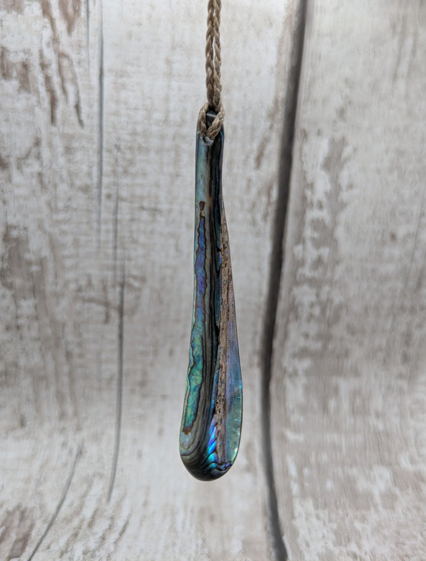New Zealand rainbow pāua rim drop pendant.