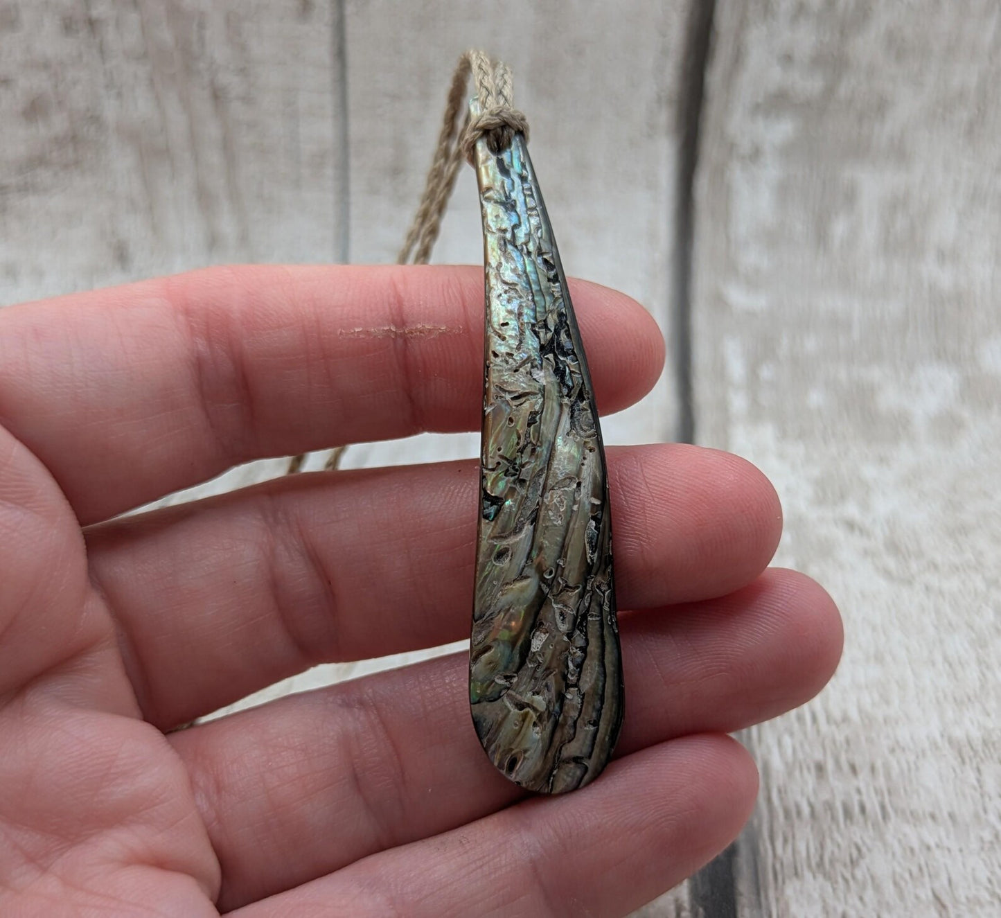 New Zealand rainbow pāua rim drop pendant.