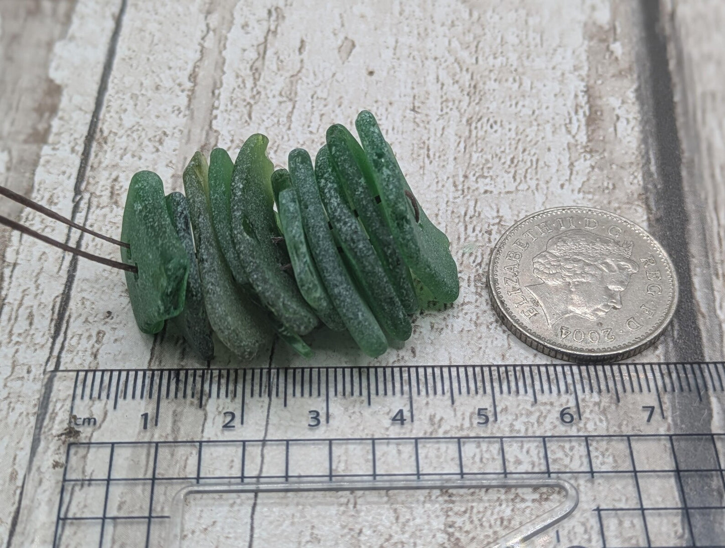 10 green frosted sea glass buttons.