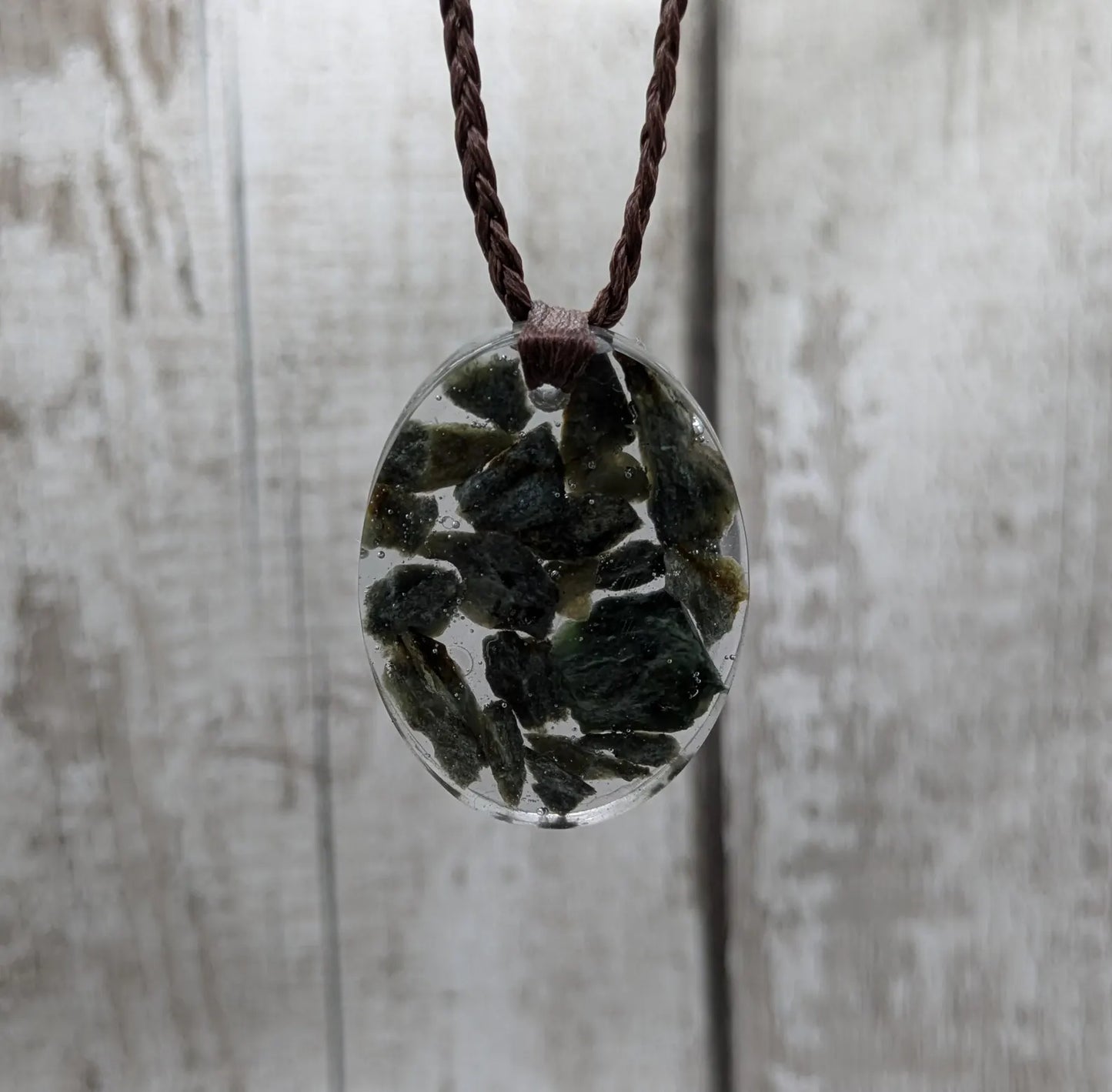 Oval mixed Pounamu jade offcuts in epoxy resin pendant.