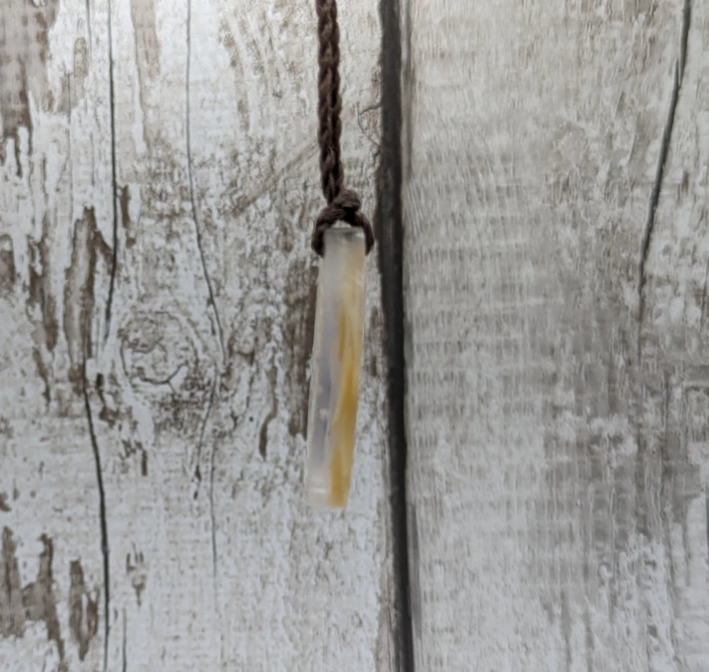 Oval mussel shell resin cast pendant.